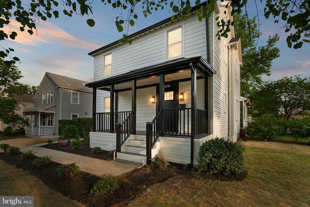 3838 13th St N, Arlington, VA 22201 - view of front of house with covered porch and a yard