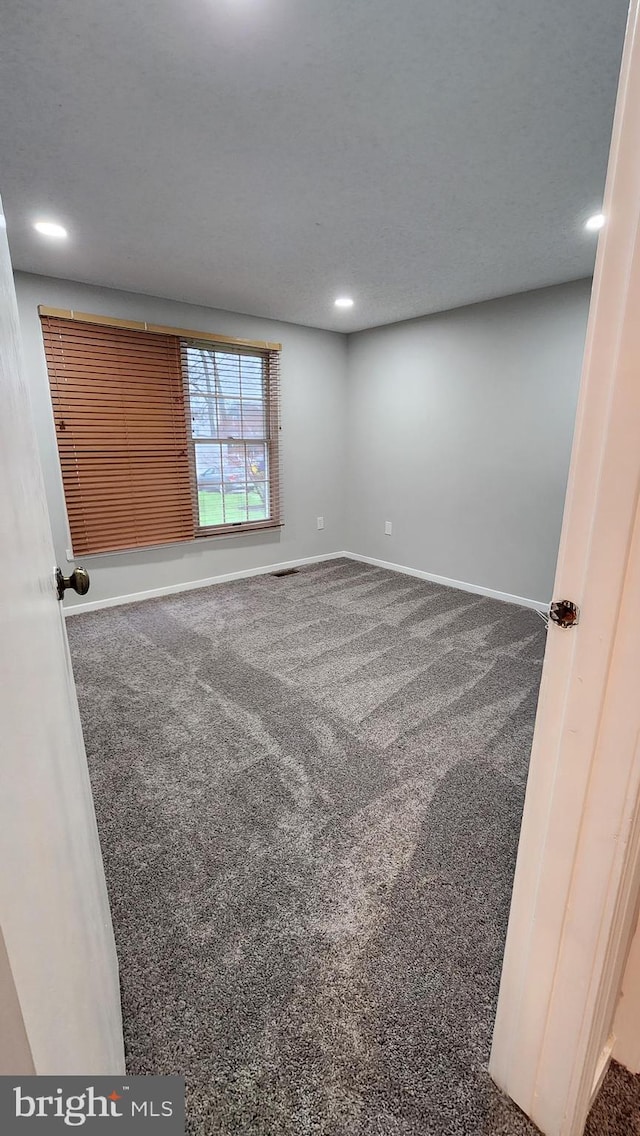 carpeted spare room with recessed lighting and baseboards