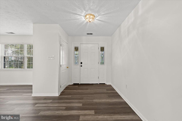 5127 Beaugregory Ct, Waldorf, MD 20603 - foyer entrance featuring a textured ceiling, visible vents, and dark wood finished floors