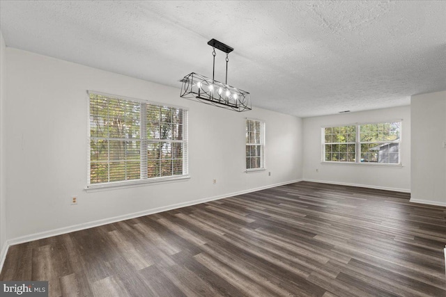 5127 Beaugregory Ct, Waldorf, MD 20603 - unfurnished dining area with dark wood finished floors, baseboards, and a textured ceiling