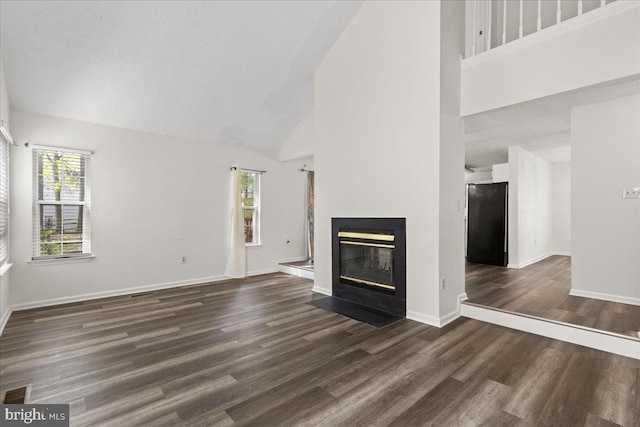 5127 Beaugregory Ct, Waldorf, MD 20603 - unfurnished living room with plenty of natural light, high vaulted ceiling, and dark wood finished floors