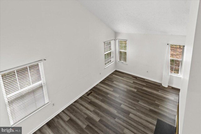 5127 Beaugregory Ct, Waldorf, MD 20603 - spare room featuring dark wood finished floors, baseboards, visible vents, a textured ceiling, and lofted ceiling