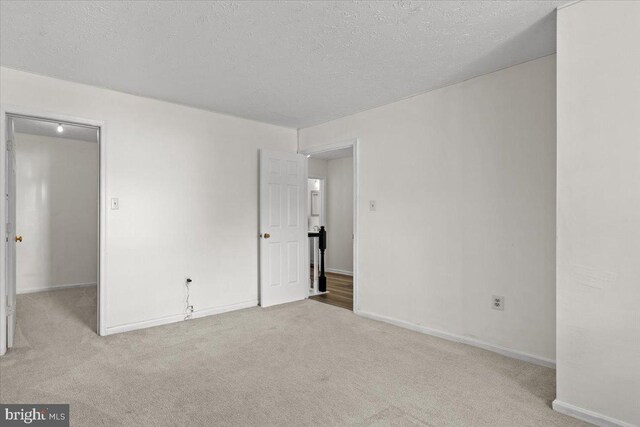5127 Beaugregory Ct, Waldorf, MD 20603 - unfurnished bedroom with baseboards, a textured ceiling, and carpet flooring