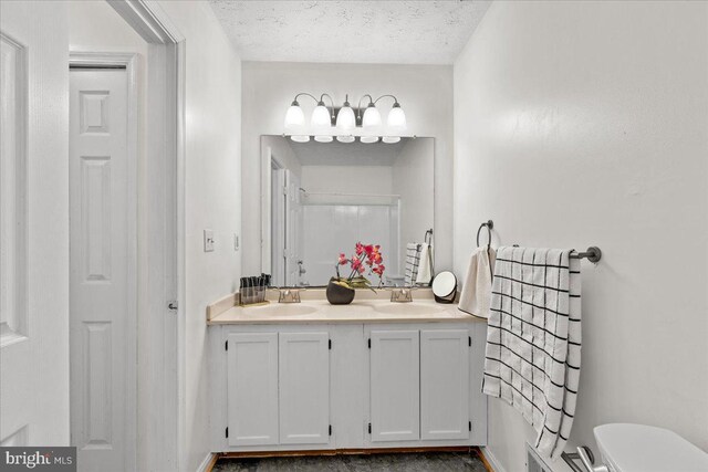 5127 Beaugregory Ct, Waldorf, MD 20603 - full bath with toilet, a textured ceiling, double vanity, and a sink