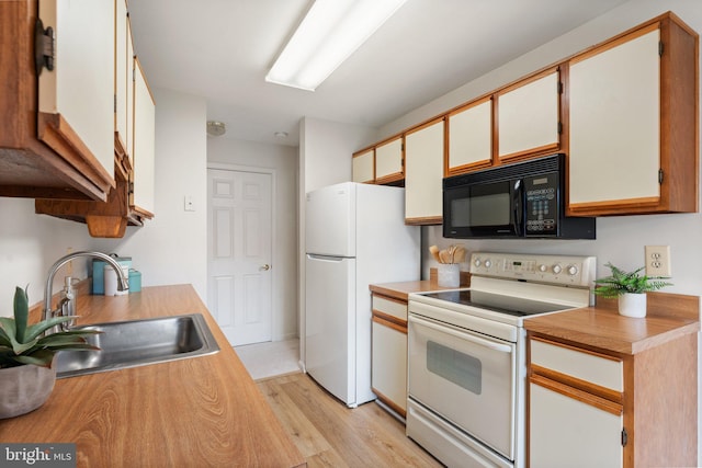 9552 Cannoneer Ct Unit 204, Manassas, VA 20110 - kitchen with white appliances, a sink, light wood-type flooring, and light countertops