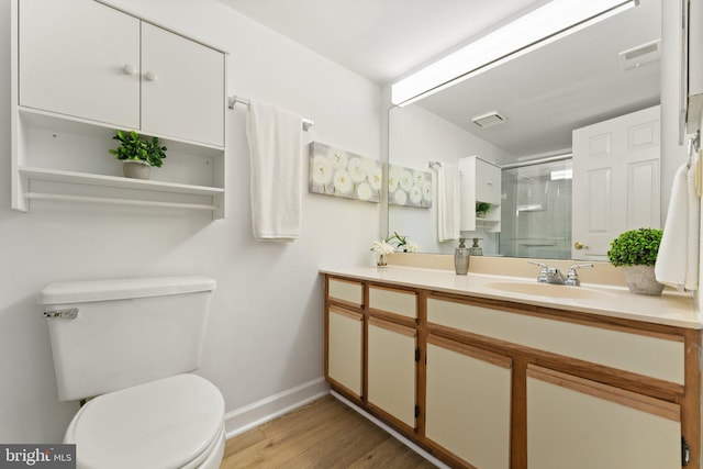 9552 Cannoneer Ct Unit 204, Manassas, VA 20110 - bathroom featuring toilet, a shower stall, wood finished floors, baseboards, and double vanity