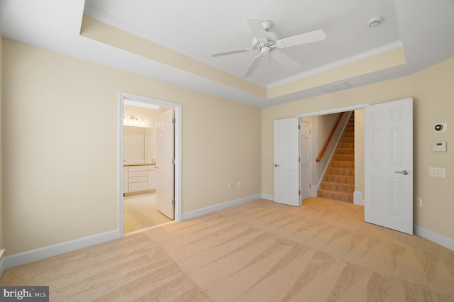 20449 Rosses Point Ct, Ashburn, VA 20147 - unfurnished bedroom featuring a tray ceiling, light colored carpet, crown molding, ensuite bathroom, and ceiling fan