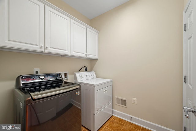 20449 Rosses Point Ct, Ashburn, VA 20147 - washroom featuring washing machine and dryer, cabinet space, and light tile patterned floors
