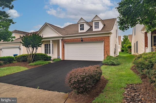 20449 Rosses Point Ct, Ashburn, VA 20147 - view of front of house with brick siding, driveway, a garage, a front yard, and roof with shingles