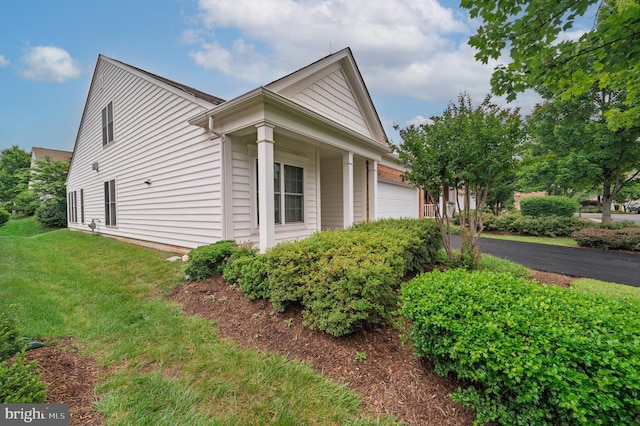20449 Rosses Point Ct, Ashburn, VA 20147 - view of side of property featuring an attached garage and a lawn