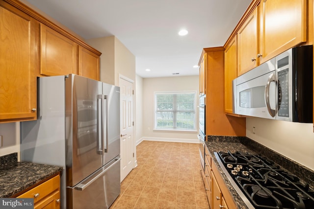 20449 Rosses Point Ct, Ashburn, VA 20147 - kitchen with appliances with stainless steel finishes, dark stone countertops, brown cabinets, and recessed lighting