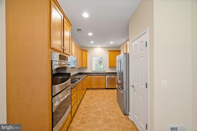 20449 Rosses Point Ct, Ashburn, VA 20147 - kitchen featuring appliances with stainless steel finishes, dark countertops, recessed lighting, and light tile patterned floors