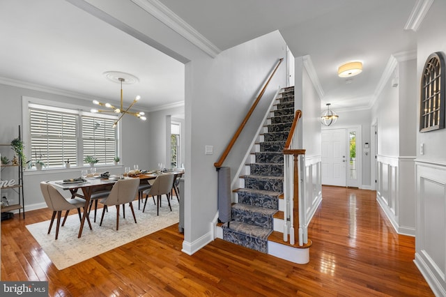 3 Union St, Robbinsville, NJ 08691 - staircase featuring a chandelier, ornamental molding, a healthy amount of sunlight, and hardwood / wood-style flooring
