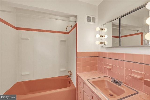 full bath featuring vanity, visible vents, and bathtub / shower combination