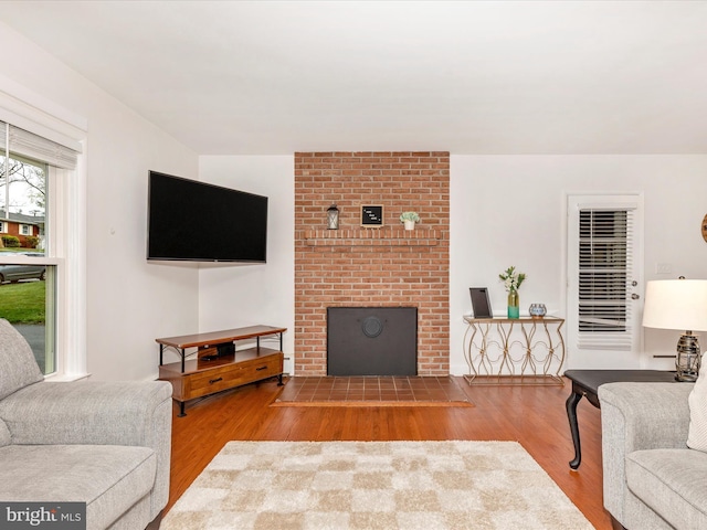 living area with wood finished floors and a fireplace