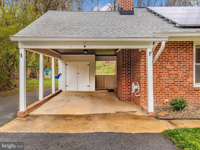 view of vehicle parking with fence and aphalt driveway