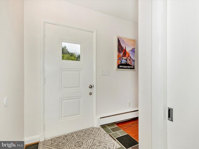 entryway featuring a baseboard heating unit and baseboards