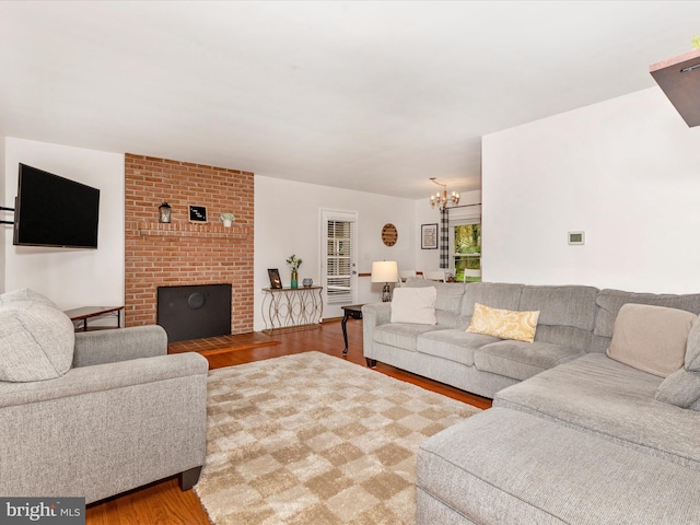 living area with a chandelier and wood finished floors