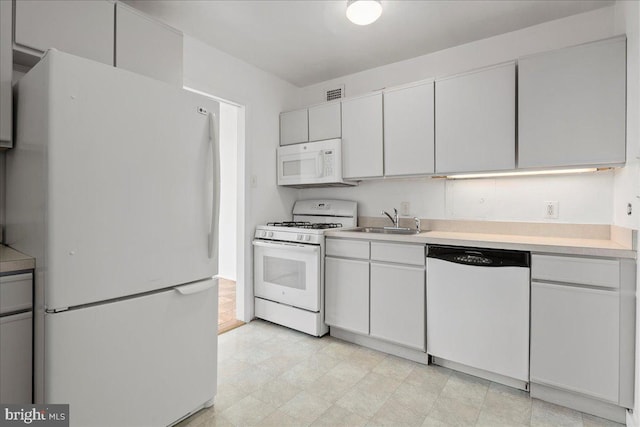4501 Arlington Blvd Unit 709, Arlington, VA 22203 - kitchen with white appliances, a sink, light countertops, and light floors
