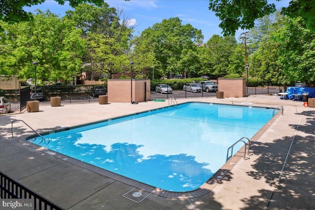 4501 Arlington Blvd Unit 709, Arlington, VA 22203 - community pool featuring a patio and view of scattered trees