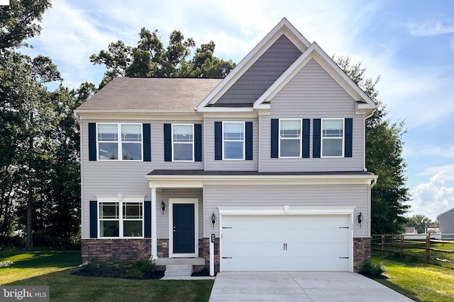 craftsman inspired home featuring a front lawn, stone siding, concrete driveway, fence, and an attached garage