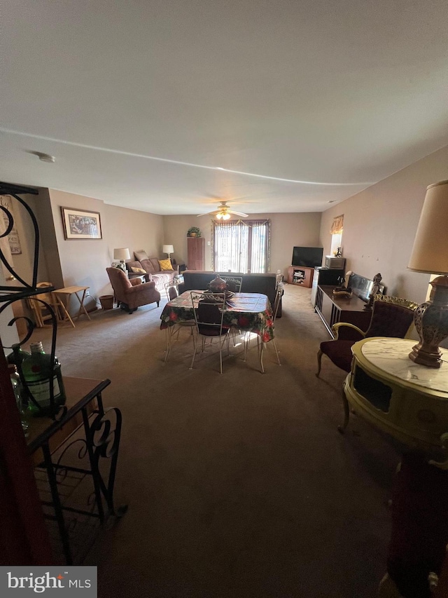 carpeted dining space featuring a ceiling fan