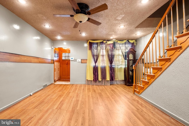 entryway with stairway, wood finished floors, ceiling fan, baseboards, and recessed lighting