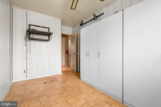 basement featuring ceiling fan and a barn door