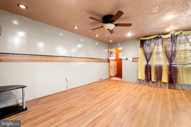empty room featuring ceiling fan, wood finished floors, a textured ceiling, and recessed lighting