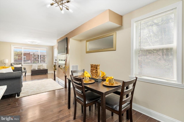 4548 Derby Manor Dr, Baltimore, MD 21215 - dining room with dark wood finished floors, visible vents, baseboards, and an inviting chandelier