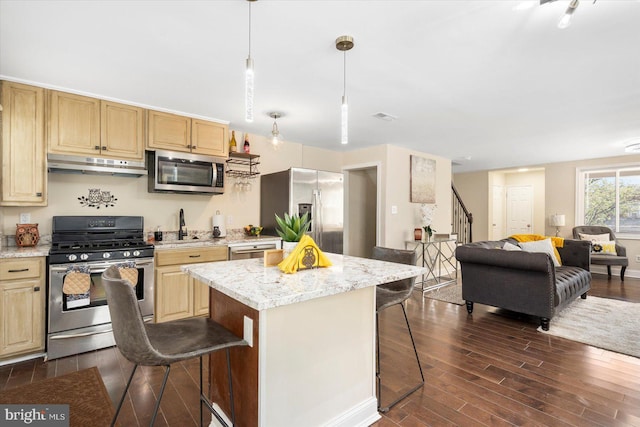 4548 Derby Manor Dr, Baltimore, MD 21215 - kitchen with open floor plan, a breakfast bar, stainless steel appliances, under cabinet range hood, and dark wood-style floors