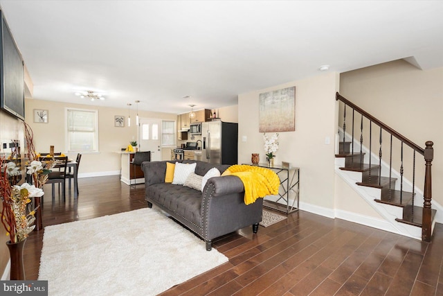 4548 Derby Manor Dr, Baltimore, MD 21215 - living area featuring dark wood-type flooring, baseboards, and stairs
