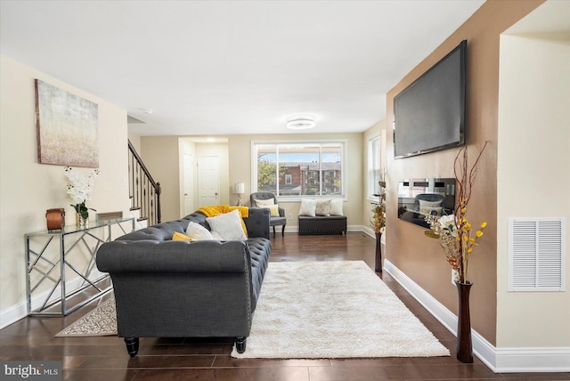 4548 Derby Manor Dr, Baltimore, MD 21215 - living room featuring baseboards, visible vents, stairs, and wood finished floors