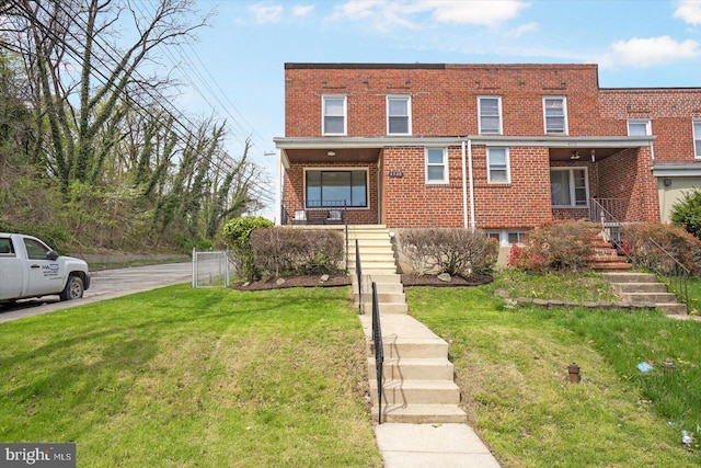 4548 Derby Manor Dr, Baltimore, MD 21215 - view of property with brick siding, a front yard, stairway, and fence
