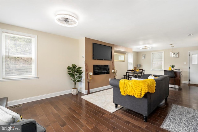 4548 Derby Manor Dr, Baltimore, MD 21215 - living area with a wealth of natural light, dark wood-style floors, and baseboards