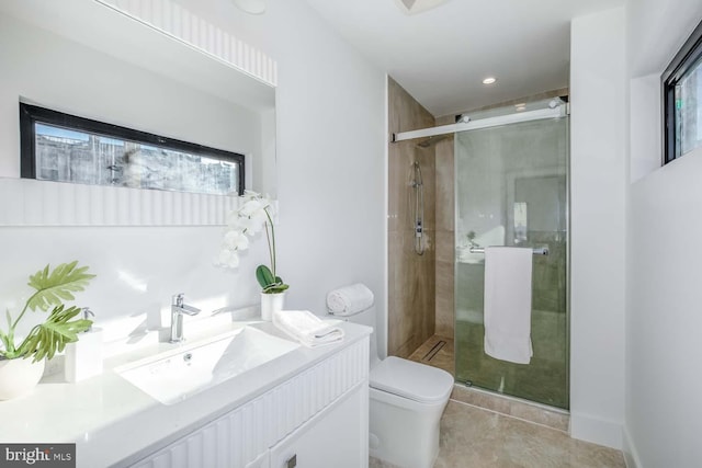 full bathroom with tile patterned floors, vanity, a shower stall, and toilet