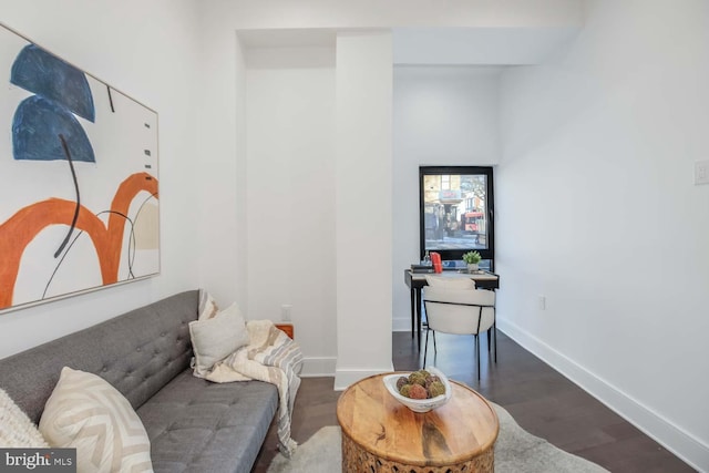 sitting room featuring baseboards and wood finished floors