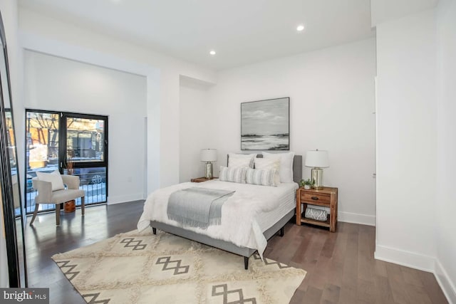 bedroom with baseboards, wood finished floors, and recessed lighting