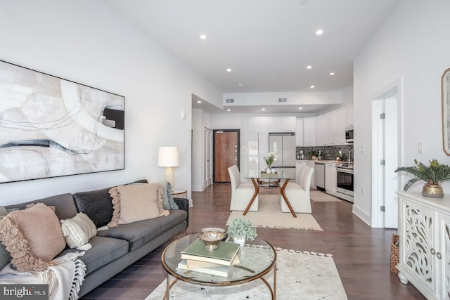 living room featuring recessed lighting, dark wood finished floors, and visible vents