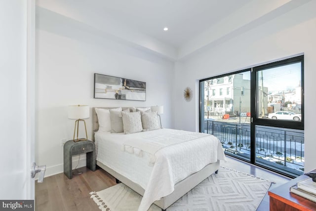 bedroom featuring recessed lighting, wood finished floors, access to exterior, and baseboards
