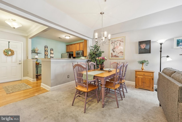 9200 Charleston Dr Unit 408, Manassas, VA 20110 - dining space featuring light carpet, a chandelier, ornamental molding, and baseboards
