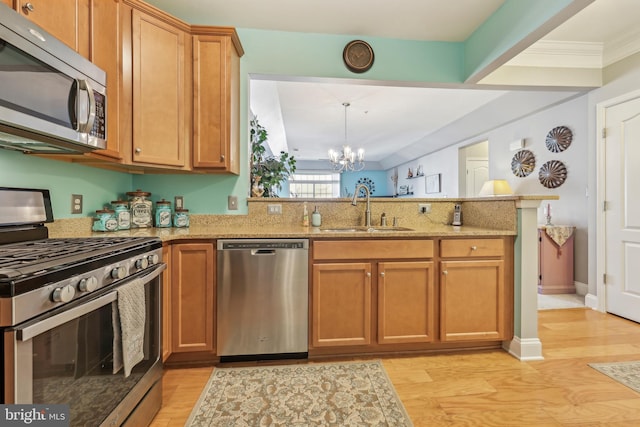 9200 Charleston Dr Unit 408, Manassas, VA 20110 - kitchen with stainless steel appliances, a sink, a chandelier, a peninsula, and light wood finished floors