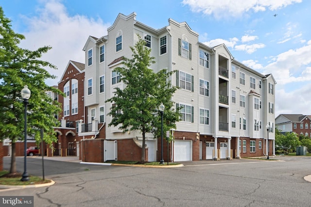 9200 Charleston Dr Unit 408, Manassas, VA 20110 - view of building exterior featuring a garage