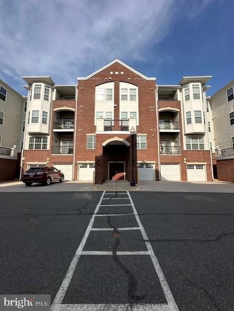 9200 Charleston Dr Unit 408, Manassas, VA 20110 - view of building exterior featuring uncovered parking