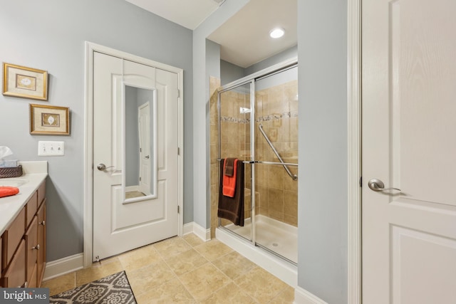 9200 Charleston Dr Unit 408, Manassas, VA 20110 - bathroom featuring a shower stall, vanity, baseboards, and tile patterned flooring