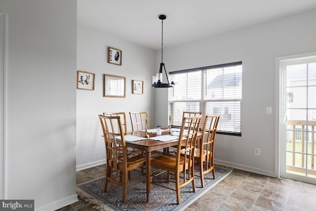 dining room featuring baseboards and stone finish flooring