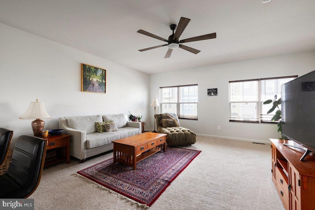 living area with baseboards, carpet flooring, and ceiling fan