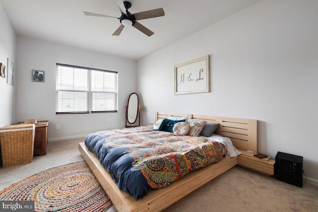 carpeted bedroom featuring baseboards and ceiling fan