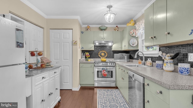 501 Tulip Rd, Riva, MD 21140 - kitchen with appliances with stainless steel finishes, under cabinet range hood, light countertops, tasteful backsplash, and crown molding