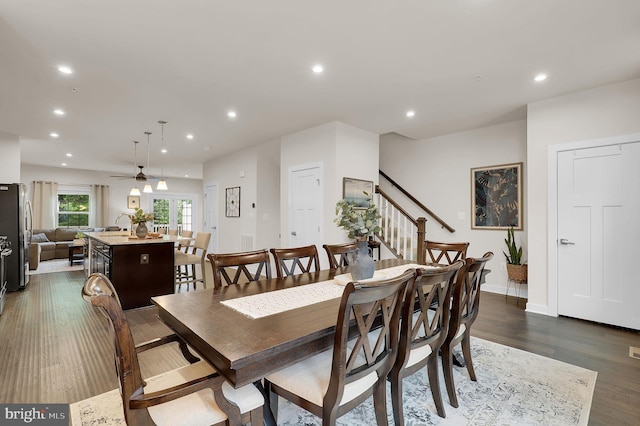 dining area with recessed lighting, dark wood finished floors, stairs, ceiling fan, and baseboards